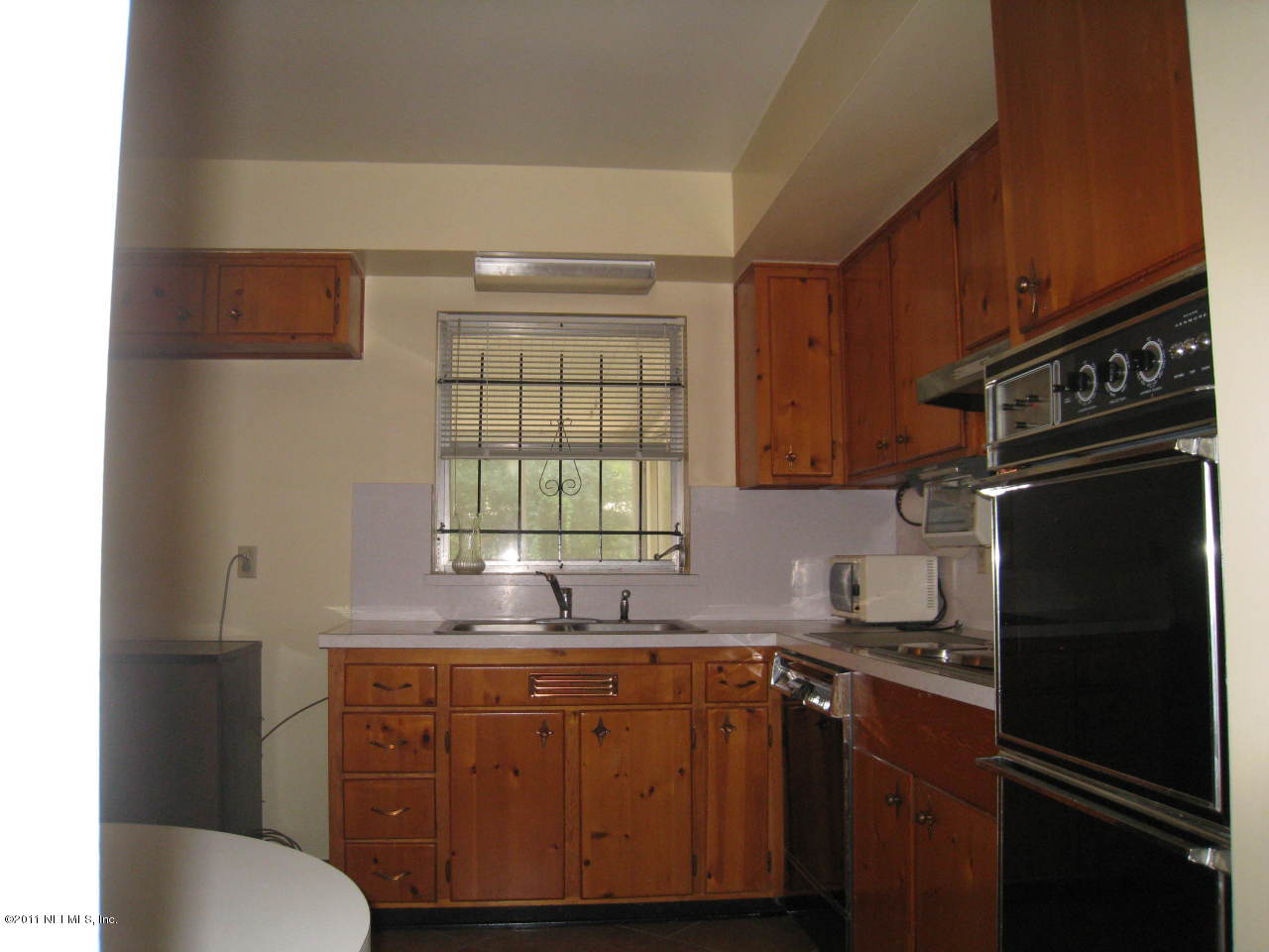7418 Centauri Road Jacksonville, FL 32210 - Photo 10 of 22 a kitchen with granite countertop a refrigerator stove and sink