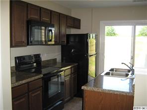 320 River Clay Road Fort Mill, SC 29708 - Photo 7 of 12 a kitchen with a stove and a refrigerator
