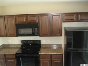 320 River Clay Road Fort Mill, SC 29708 - Photo 8 of 12 a kitchen with granite countertop a stove and a microwave