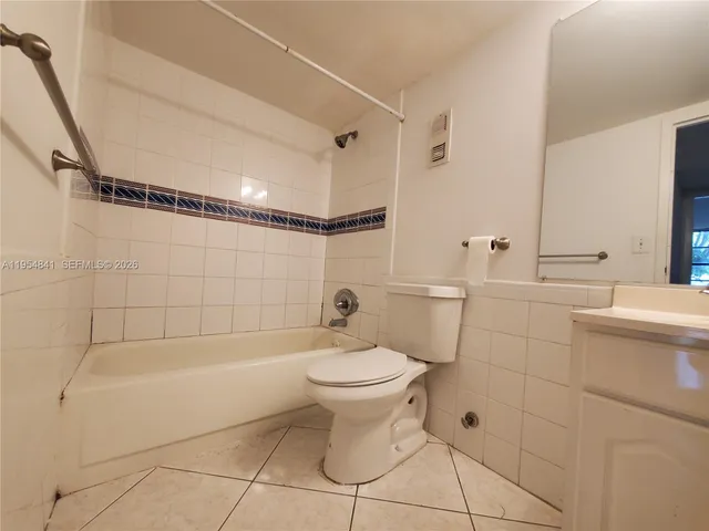 a bathroom with a toilet sink and shower