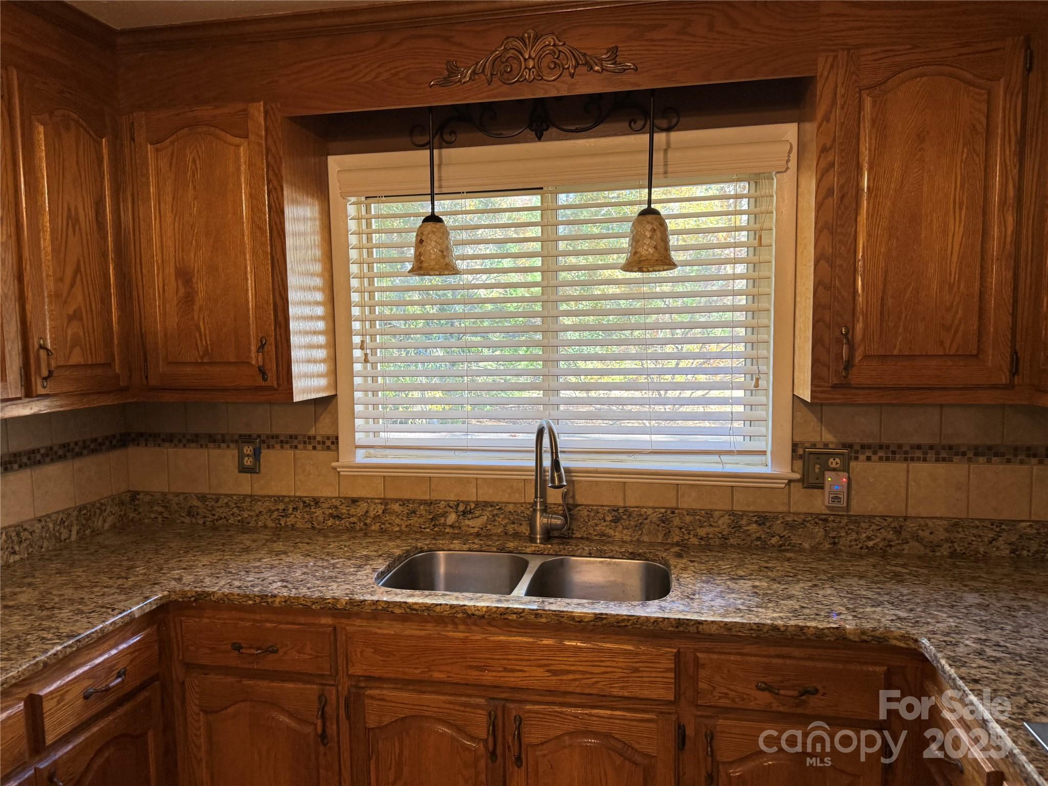 110 Forest Drive Locust, NC 28097 - Photo 12 of 29 a kitchen with granite countertop sink and cabinets