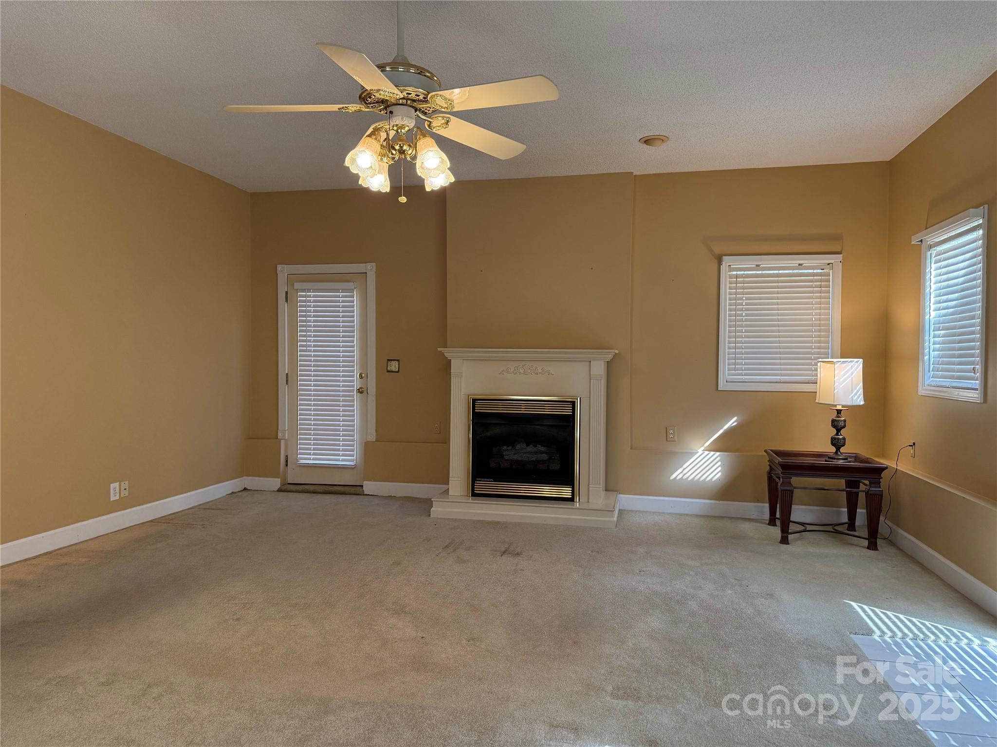 110 Forest Drive Locust, NC 28097 - Photo 20 of 29 a view of a livingroom with a fireplace and a chandelier