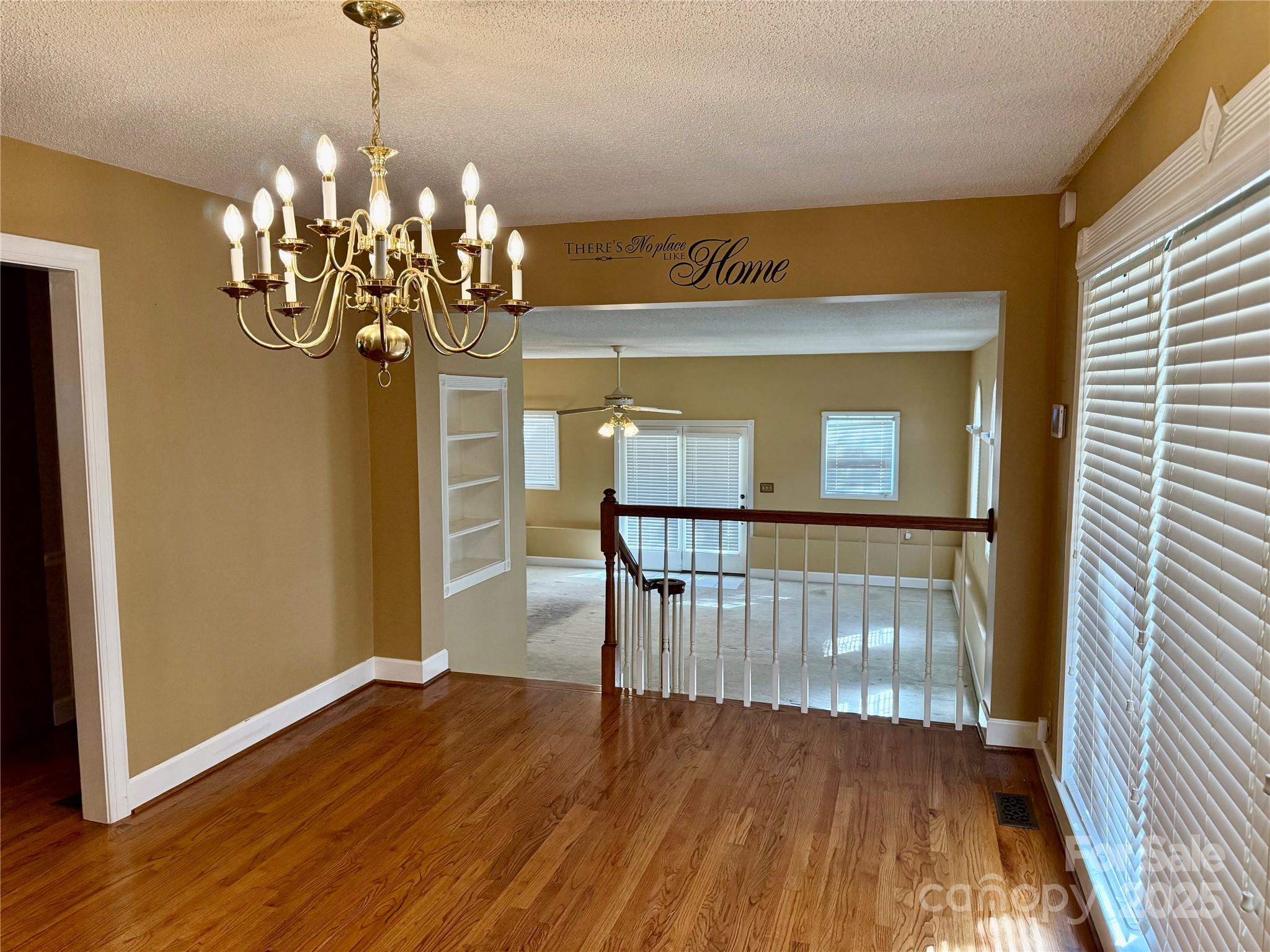 110 Forest Drive Locust, NC 28097 - Photo 22 of 29 a view of a room with wooden floor windows and a chandelier