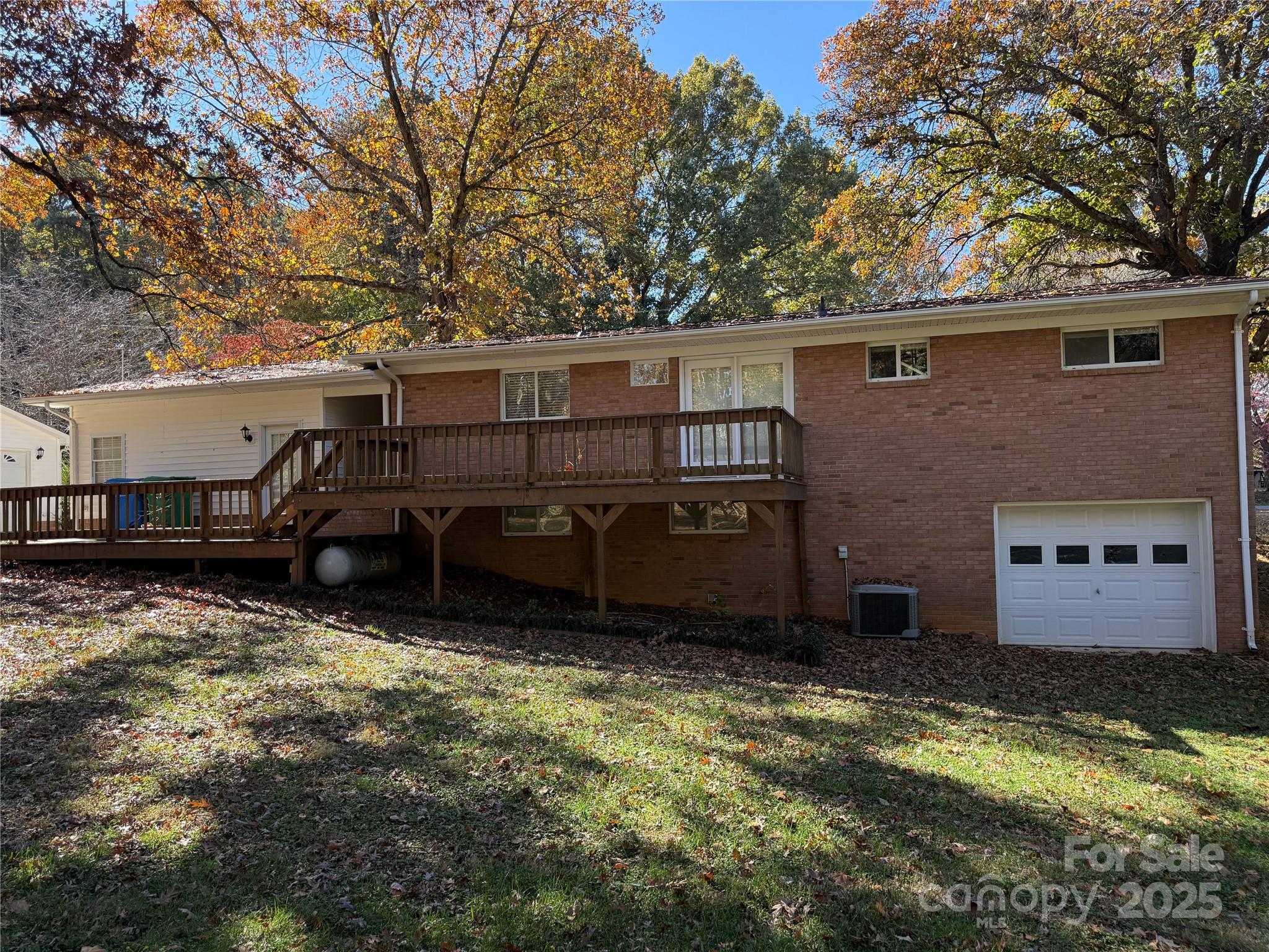 110 Forest Drive Locust, NC 28097 - Photo 9 of 29 a view of a house with a yard and a large tree