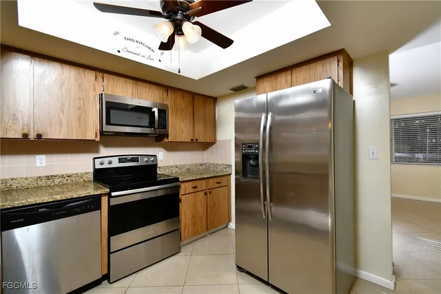 a room with chandelier and windows