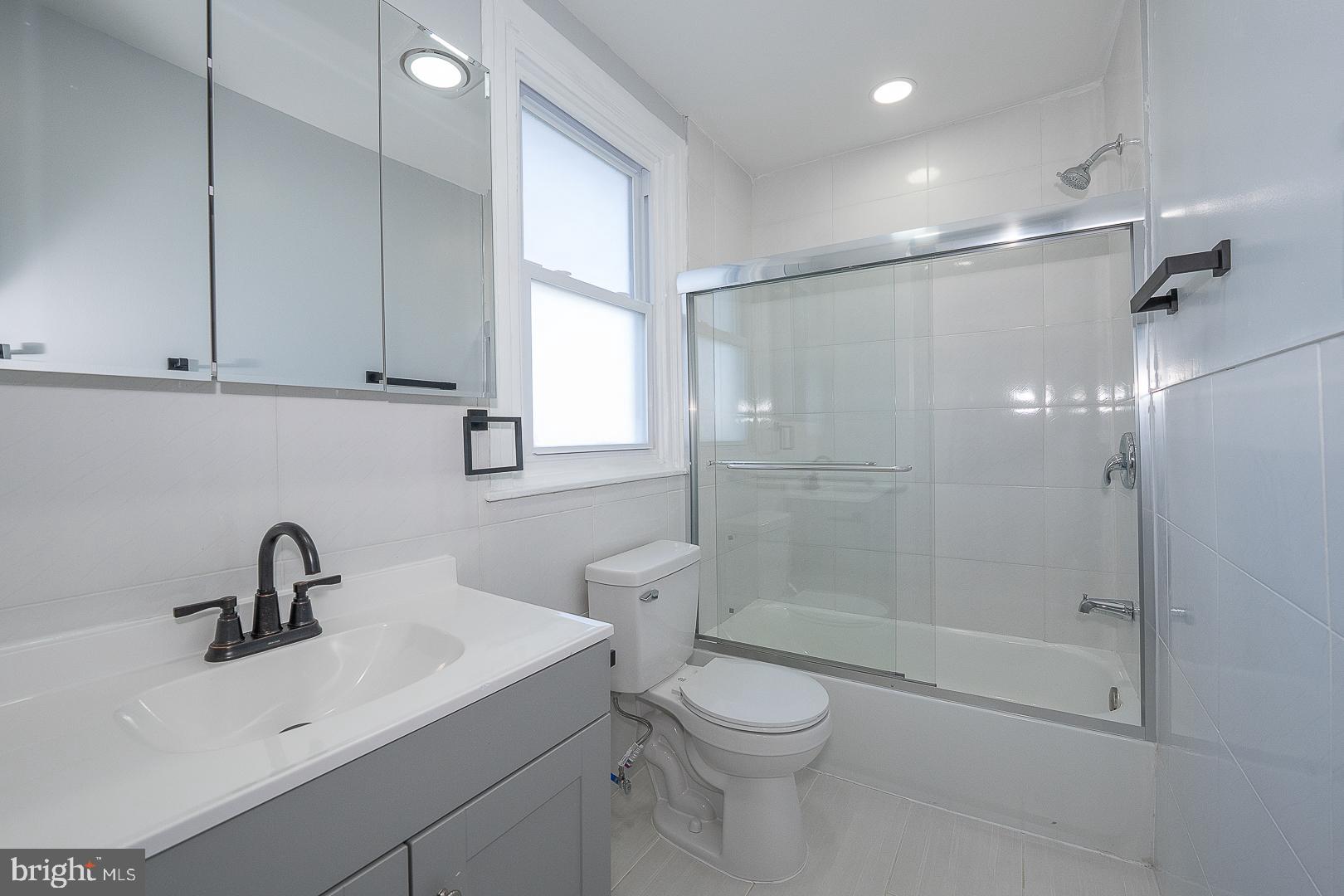 100 Englewood Road Upper Darby, PA 19082 - Photo 35 of 88 a bathroom with a shower sink vanity and toilet