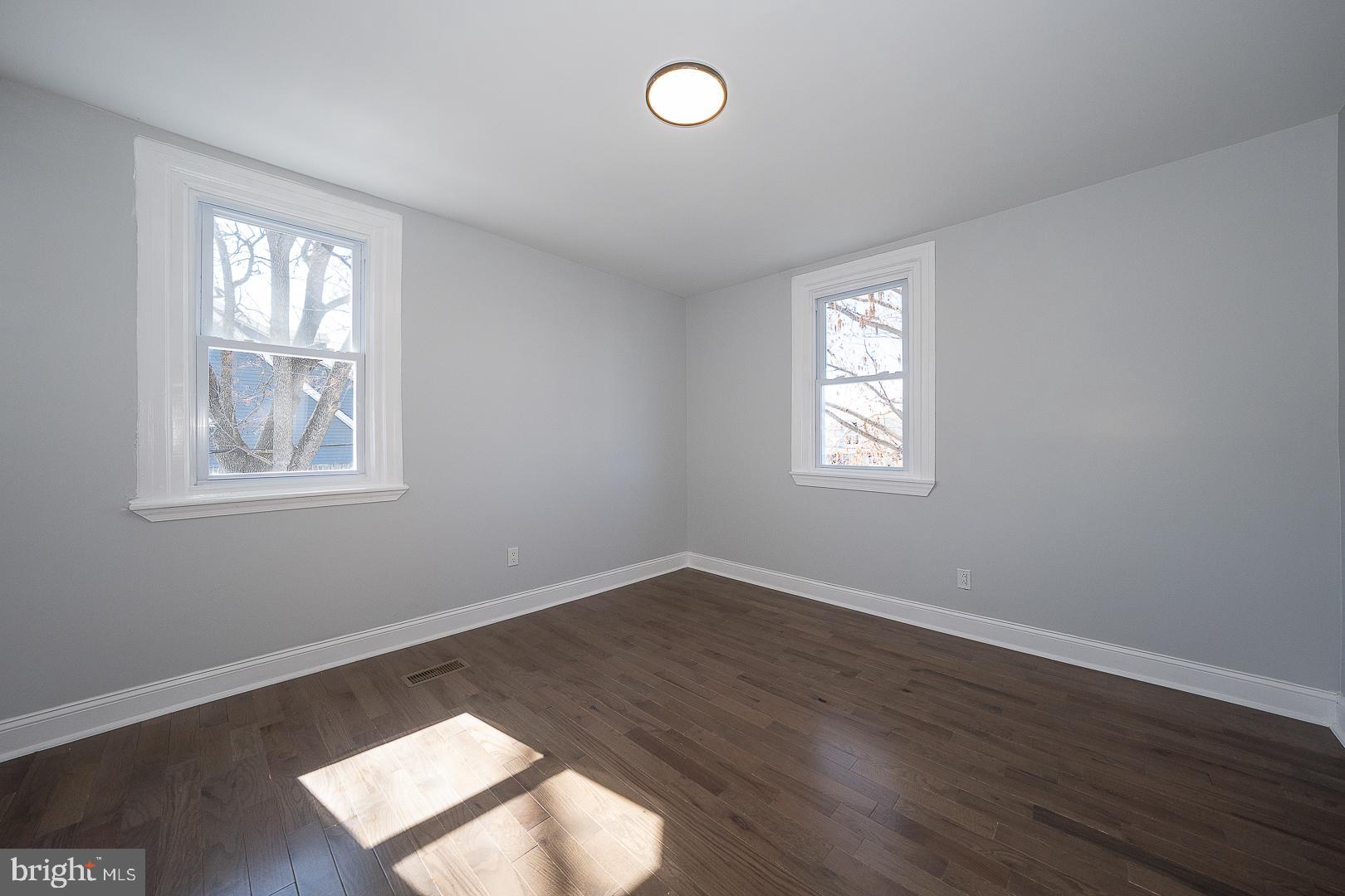 100 Englewood Road Upper Darby, PA 19082 - Photo 38 of 88 a view of an empty room with wooden floor and window