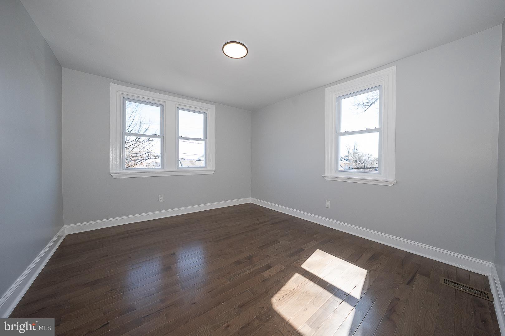 100 Englewood Road Upper Darby, PA 19082 - Photo 41 of 88 a view of an empty room with wooden floor and a window