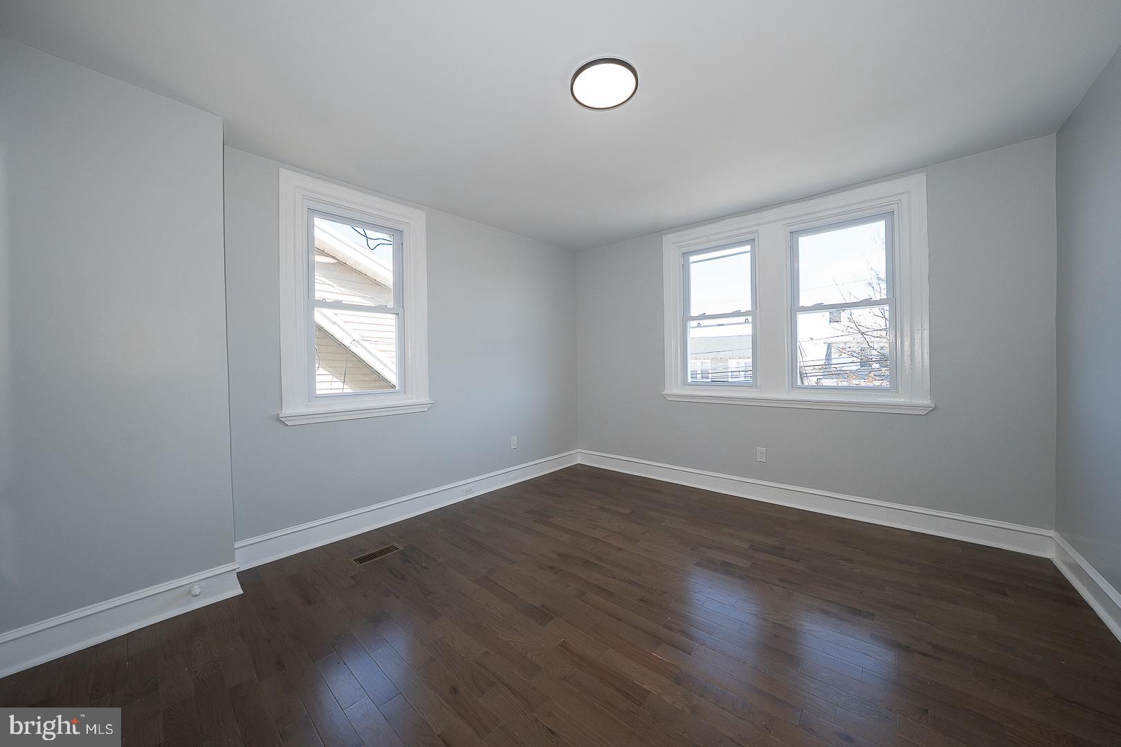100 Englewood Road Upper Darby, PA 19082 - Photo 44 of 88 an empty room with wooden floor and windows
