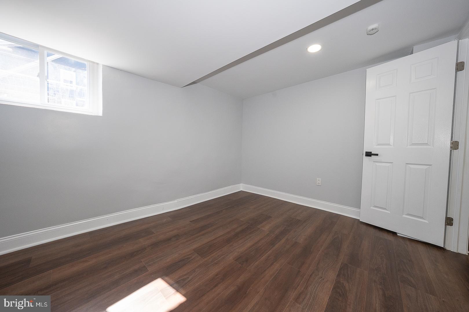 100 Englewood Road Upper Darby, PA 19082 - Photo 60 of 88 a view of an empty room with wooden floor and a window