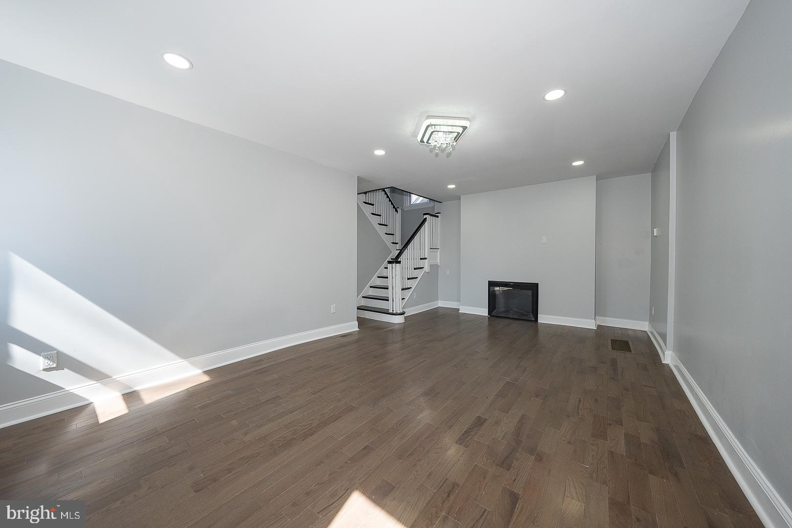 100 Englewood Road Upper Darby, PA 19082 - Photo 6 of 88 a view of an empty room with wooden floor and stairs