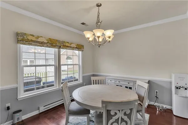 a view of a dining room with furniture wooden floor and chandelier