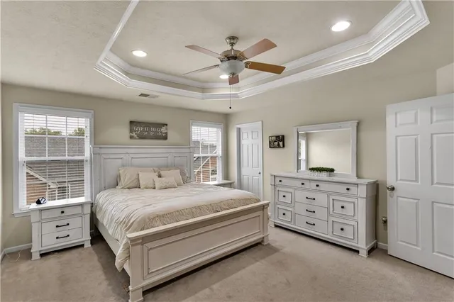 a bedroom with a large bed and a chandelier