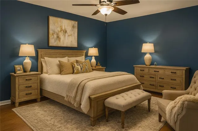 a bedroom with a bed and a lamp on dresser