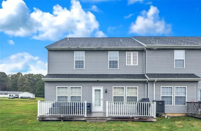 a view of a house with a backyard