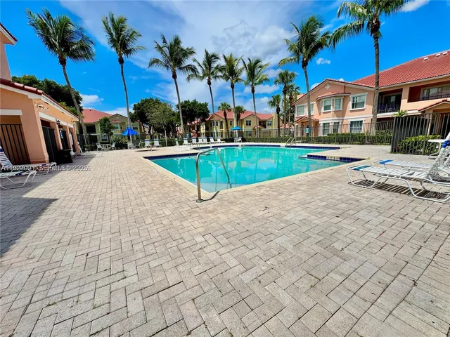 a view of house with outdoor space and swimming pool
