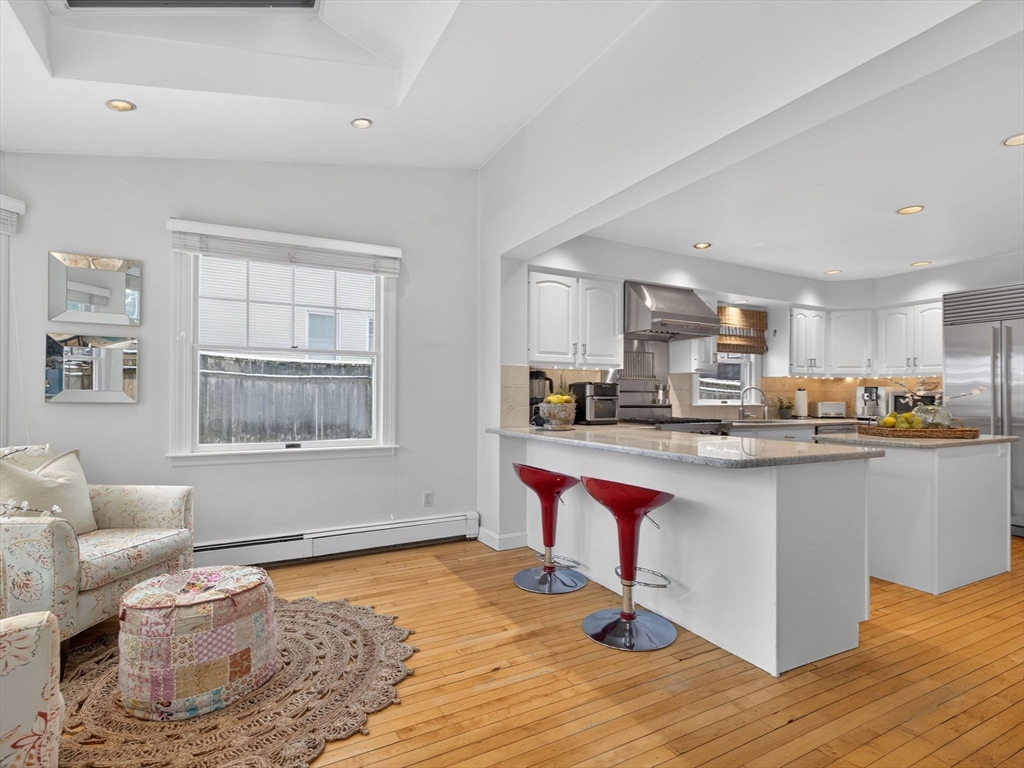 78 Denton Road Wellesley, MA 02482 - Photo 11 of 29 a living room with stainless steel appliances kitchen island granite countertop furniture and a wooden floor