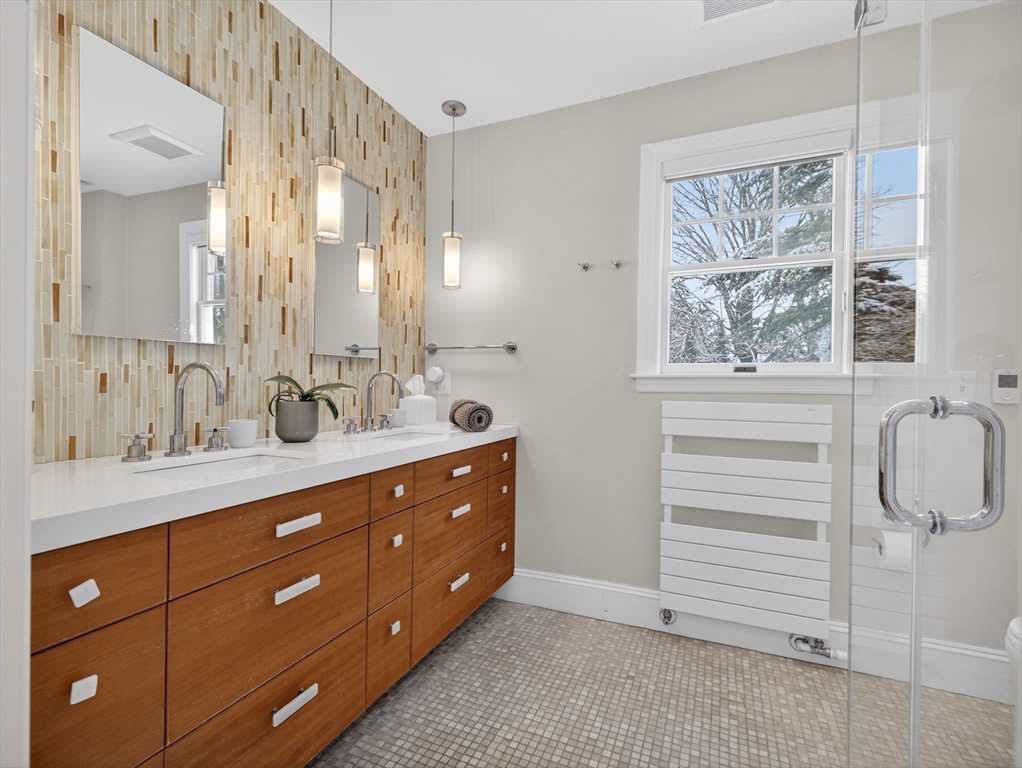 78 Denton Road Wellesley, MA 02482 - Photo 20 of 29 a spacious bathroom with a double vanity sink a large mirror and a shower