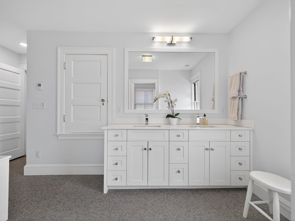 78 Denton Road Wellesley, MA 02482 - Photo 22 of 29 a bathroom with a double vanity sink a mirror and a bathtub