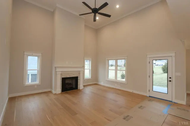 an empty room with windows and fireplace