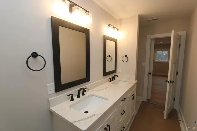 a bathroom with a double vanity sink mirror and double