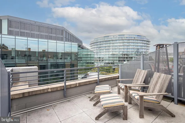 a view of a hallway with bathroom and glass door