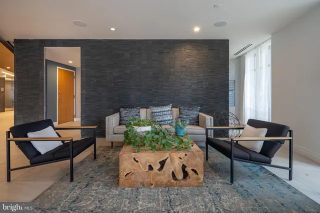 a backyard of a house with sofas table and chairs