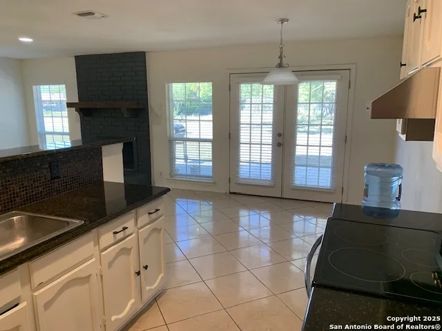 a kitchen with granite countertop a stove a sink and a granite counter tops