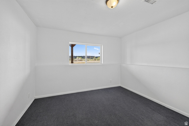 1 Tobe Day Road La Sal, UT 84530 - Photo 64 of 67 Neutral interior room featuring white walls and dark grey carpet flooring