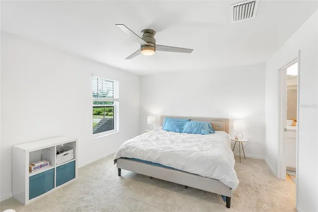 a bedroom with a bed and window