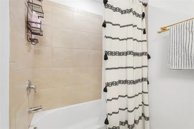 a bathroom with a bathtub and shower