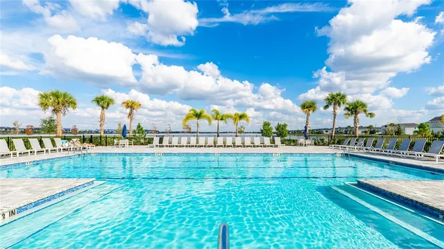 a view of a fountain in front of a house with a big yard