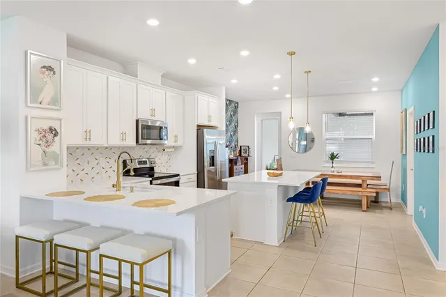 a kitchen with stainless steel appliances kitchen island granite countertop a sink and cabinets