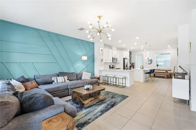 a living room with furniture and kitchen view