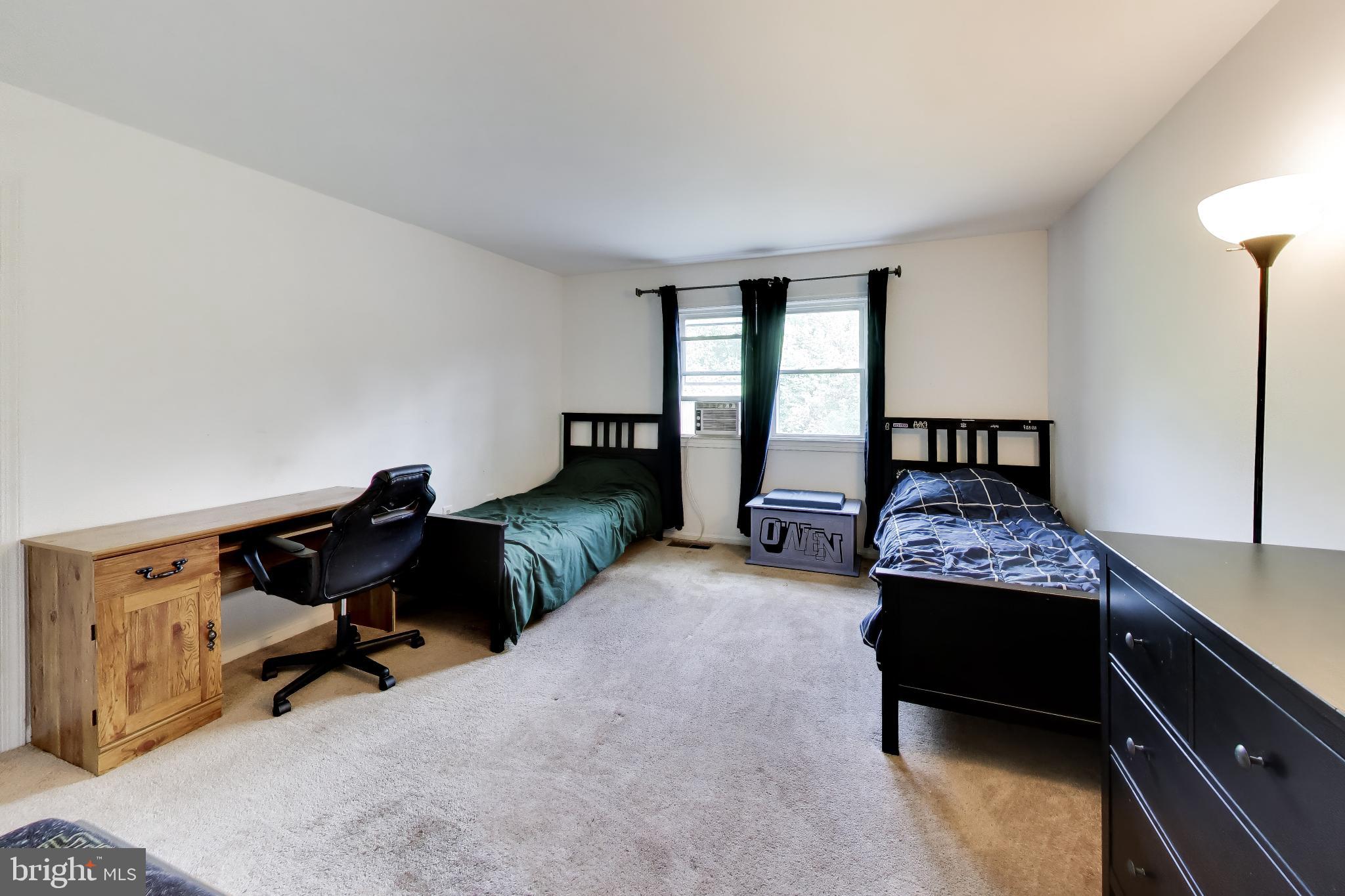 3240 Juniper Lane Huntingtown, MD 20639 - Photo 16 of 48 a bedroom with a bed and a chandelier