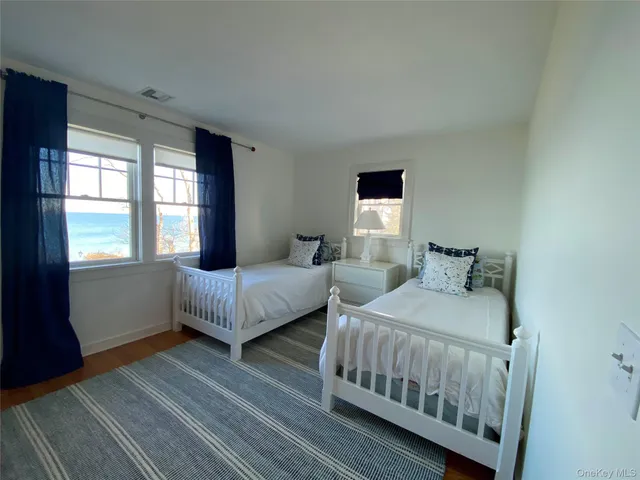 a bedroom with two beds and a window