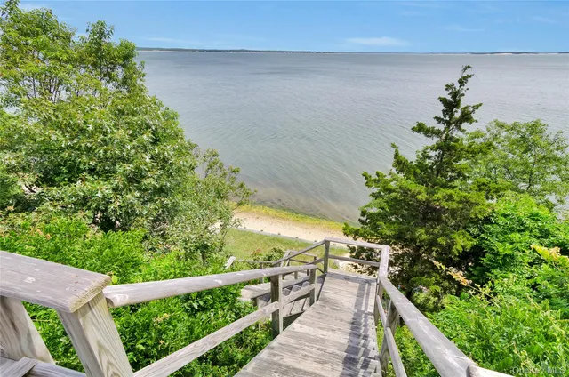 a front view of a house with a yard table and chairs