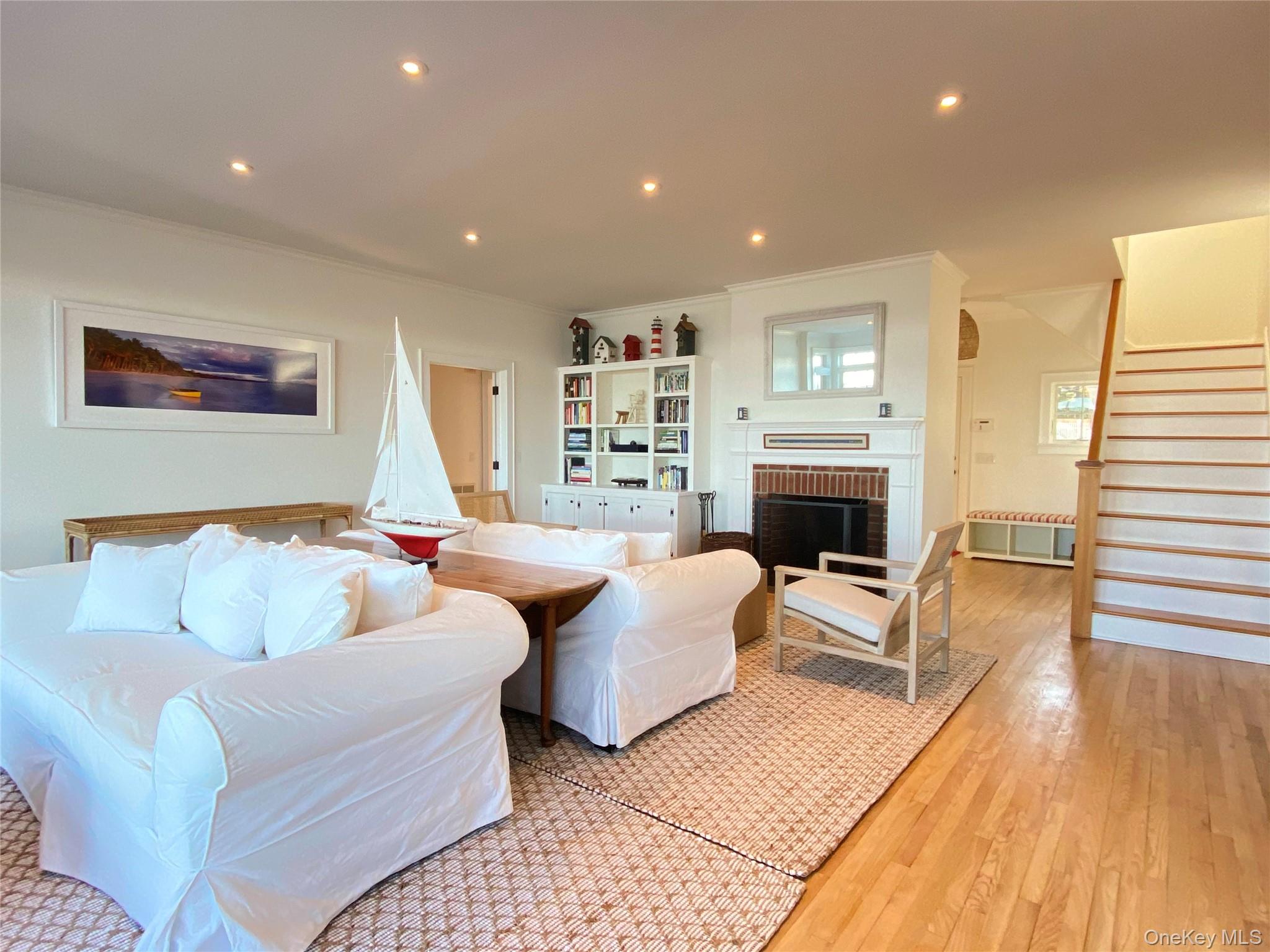 4705 Nassau Point Road Cutchogue, NY 11935 - Photo 4 of 26 a living room with furniture and a fireplace