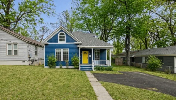 a front view of a house with garden