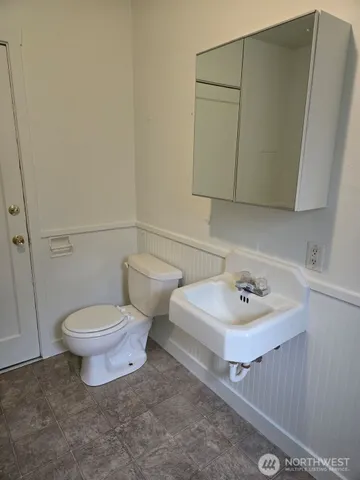 a bathroom with a sink toilet and mirror