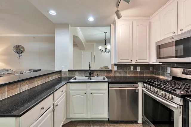 a view of a dining room with furniture wooden floor and chandelier