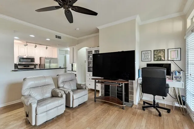 a view of a dining room with furniture wooden floor and chandelier