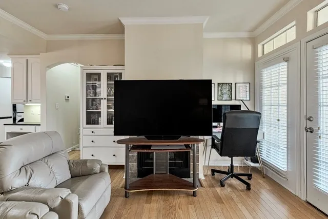 a view of a dining room with furniture wooden floor and chandelier