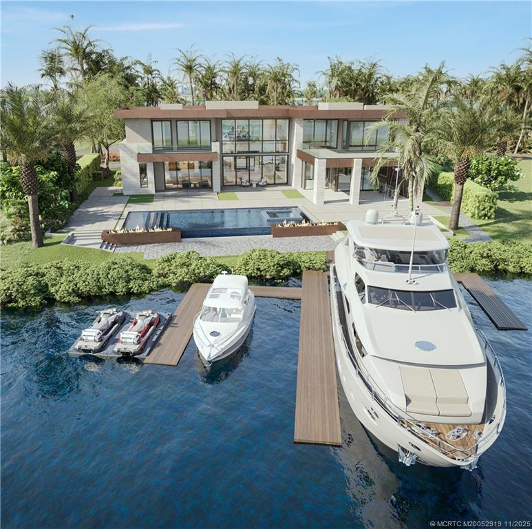 2421 Bahia Way Stuart, FL 34996 - Photo 2 of 63 an aerial view of a house with a swimming pool