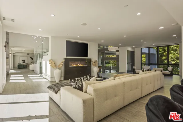 a living room with fireplace furniture and a flat screen tv