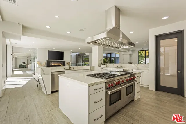 a kitchen with a stove top oven and cabinets