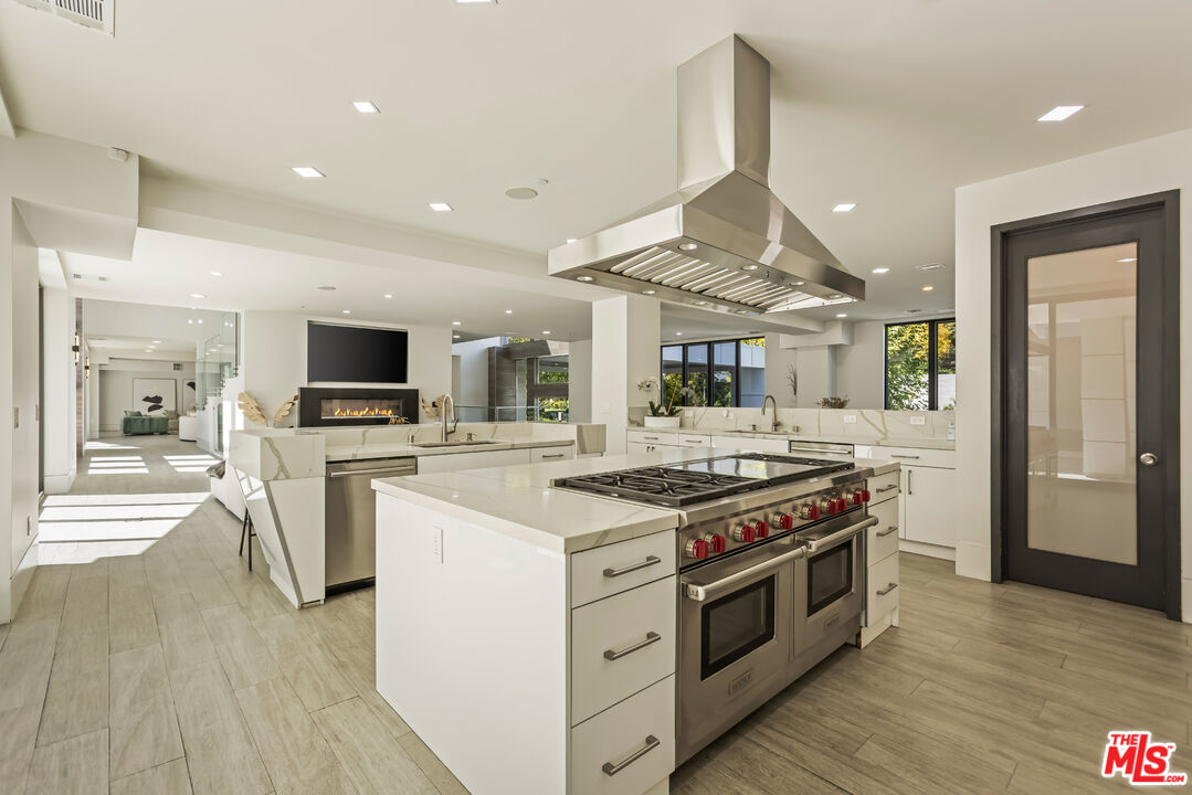 4230 Valley Meadow Road Encino, CA 91436 - Photo 15 of 44 a kitchen with a stove top oven and cabinets