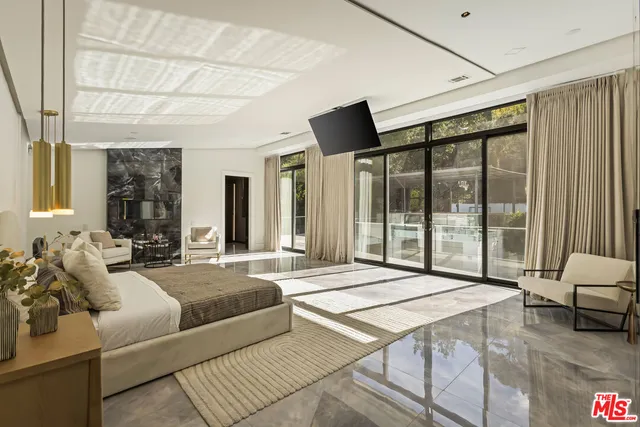 a bedroom with a large bed and a large window