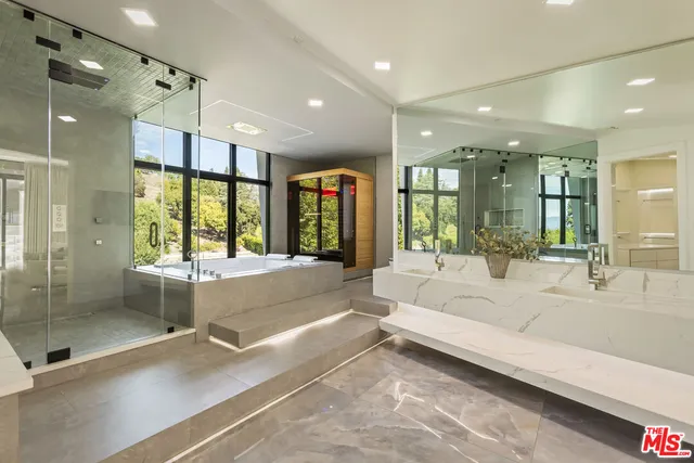 a large spacious bathroom with a large tub and shower