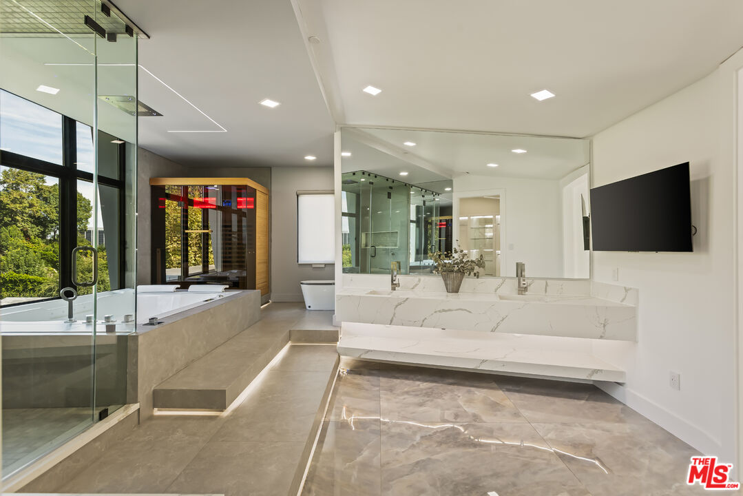 4230 Valley Meadow Road Encino, CA 91436 - Photo 21 of 44 a large white building with glass door and chandelier